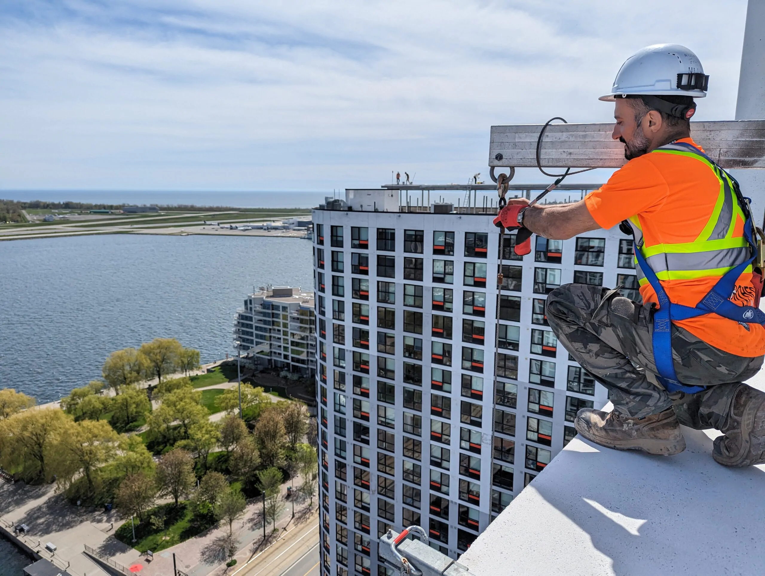 Swing stage rigging setup for high-rise building facade restoration in Toronto by NHC Restoration