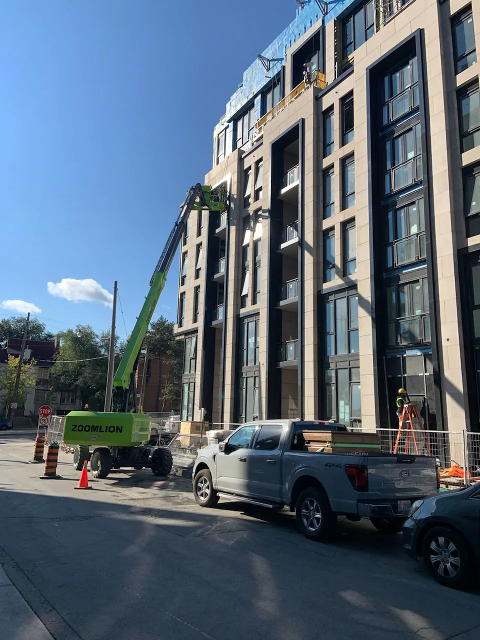 Boom lift cherry picker providing horizontal and vertical access for building restoration in Toronto GTA