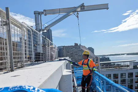 NHC crew on a swing stage during Structural Restoration in Toronto on a high rise condo
